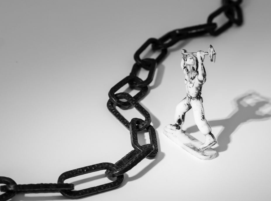 Worker breaking chains