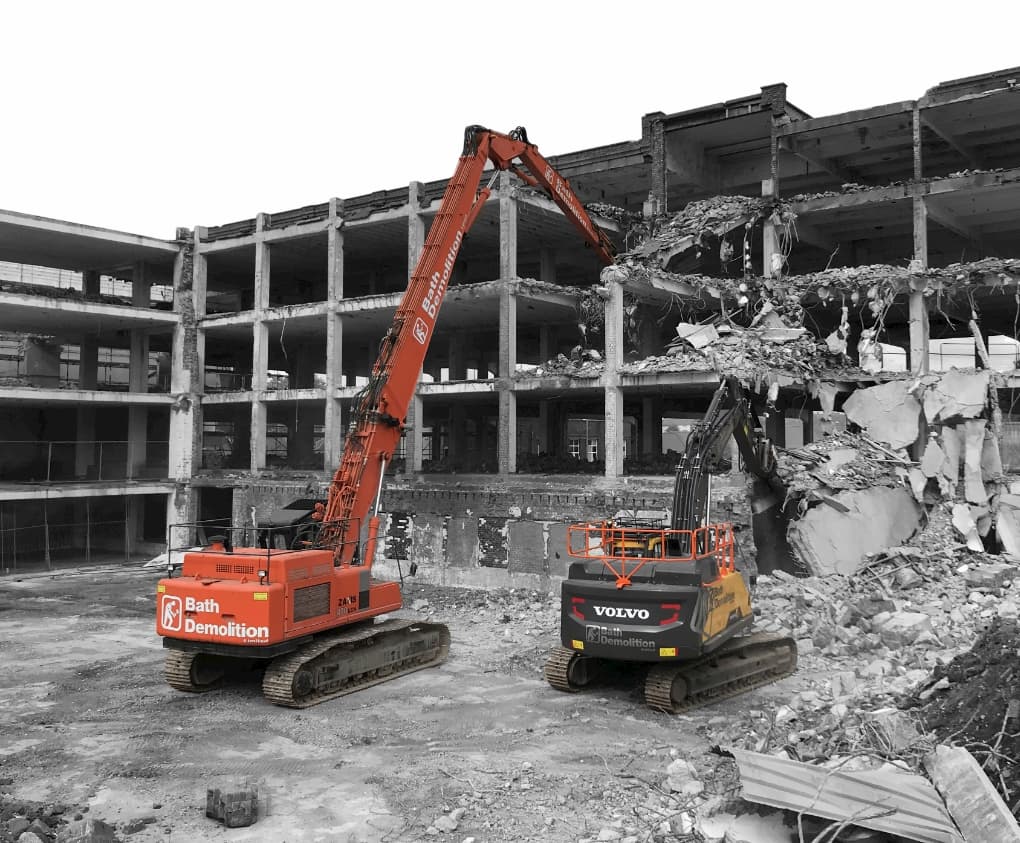 Two demolition diggers from Bath Demolition, carrying out a demolition project in Bristol. Site clearance project to follow and aid with concrete recycling